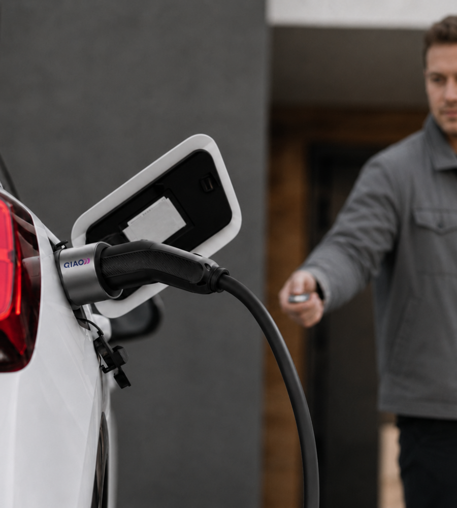 Man charging an electric car with a QIAO Q6 EV charger.